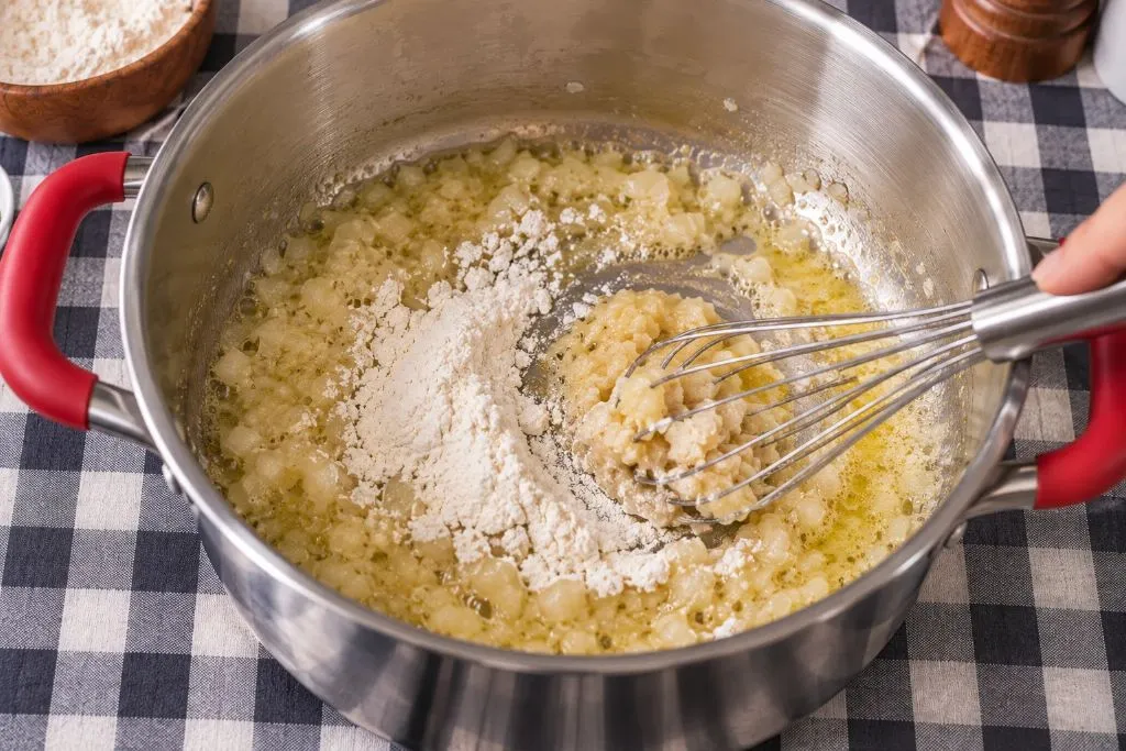 Making a roux with butter, onion and flour for broccoli cheddar soup